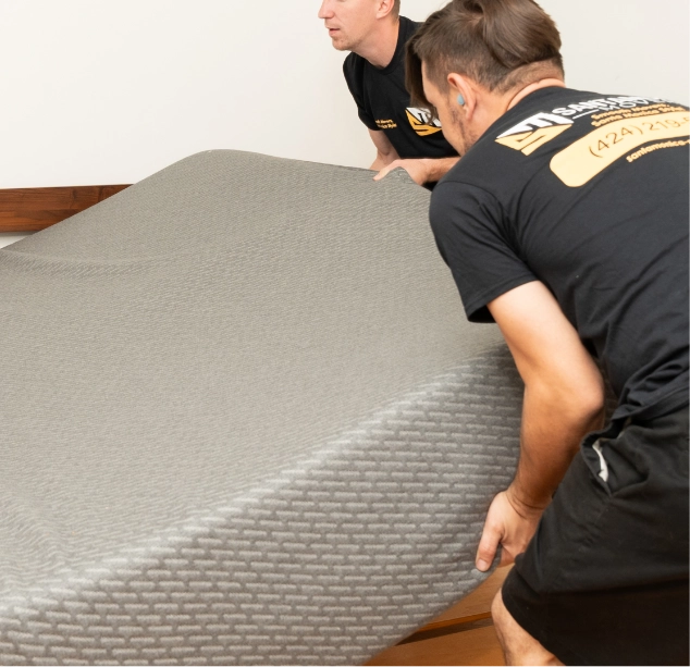 Movers lifting a mattress